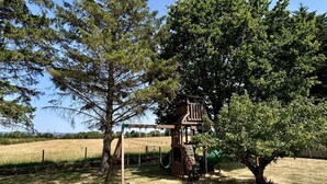 A playground with a wooden climbing structure, swings, and a slide. - 2 Bed in Duddlestone (oc-q34588) (Duddlestone)