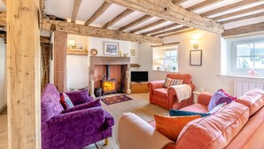 A cozy living room with exposed wooden beams, a fireplace, and comfortable seating. - 2 Bed in Long Marton (oc-c34661) (Long Marton)