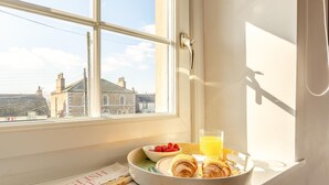 A breakfast tray with croissants, a bowl of raspberries, and a glass of orange juice on a windowsill with a newspaper. - 2 Bed in Long Marton (oc-c34661) (Long Marton)