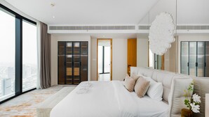 A modern hotel room with a large bed, a view of the city, and a large window. - Address JBR 3BR Direct Beach Ain Dubai View (Dubai)