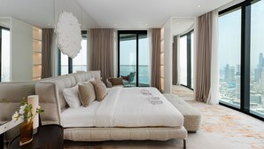 A modern bedroom with a large bed, a seating area, and a city view. - Address JBR 3BR Direct Beach Ain Dubai View (Dubai)