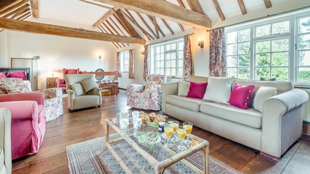 A spacious living room with wooden beams, a sofa set, and a coffee table with drinks. - 3 Bed in Awre (oc-s34503) (Awre)