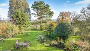 A well-maintained garden with a dining area, including a table and chairs. - 3 Bed in Awre (oc-s34503) (Awre)