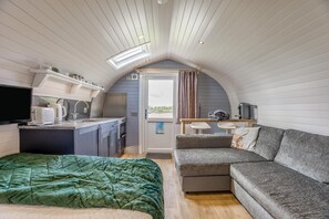 A compact, well-lit room with a kitchenette, a sofa, and a bed. - 1 Bed in Forfar (oc-t34621) (Forfar)