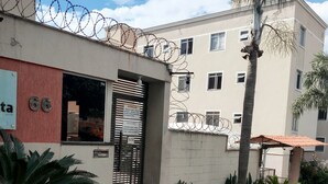 A building with a barred entrance, a number '66' sign, and a wheelchair-accessible ramp.