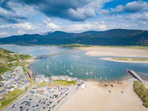 A coastal town with a marina, sandy beach, and a bridge connecting to the mainland. - 4 Bed in Ganllwyd (oc-g34601) (Ganllwyd)