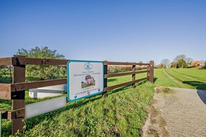 A sign for a self-catering holiday accommodation with a contact number and website. - 1 Bed in Foulsham (oc-j34678) (Foulsham)