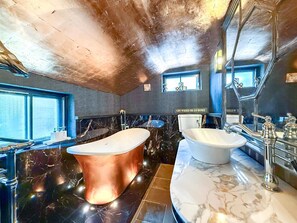 A modern bathroom with a large bathtub, two sinks, and a mirror. - 4 Bed in Lavenham (oc-o34469) (Lavenham)