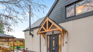 A house with a dark front door, a wooden porch, and a clear sky. - 2 Bed in Alnwick (oc-e34719) (Alnwick)