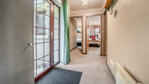 A hallway leading to a bedroom with a bed, a window, and a ceiling light fixture. - 3 Bed in Dailly (oc-r34760) (Dailly)