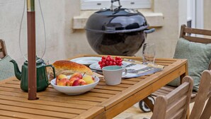 A wooden table with a teapot, a bowl of fruit, a loaf of bread, and a glass of water. - 4 Bed in Galmpton (oc-h34756) (South Huish)