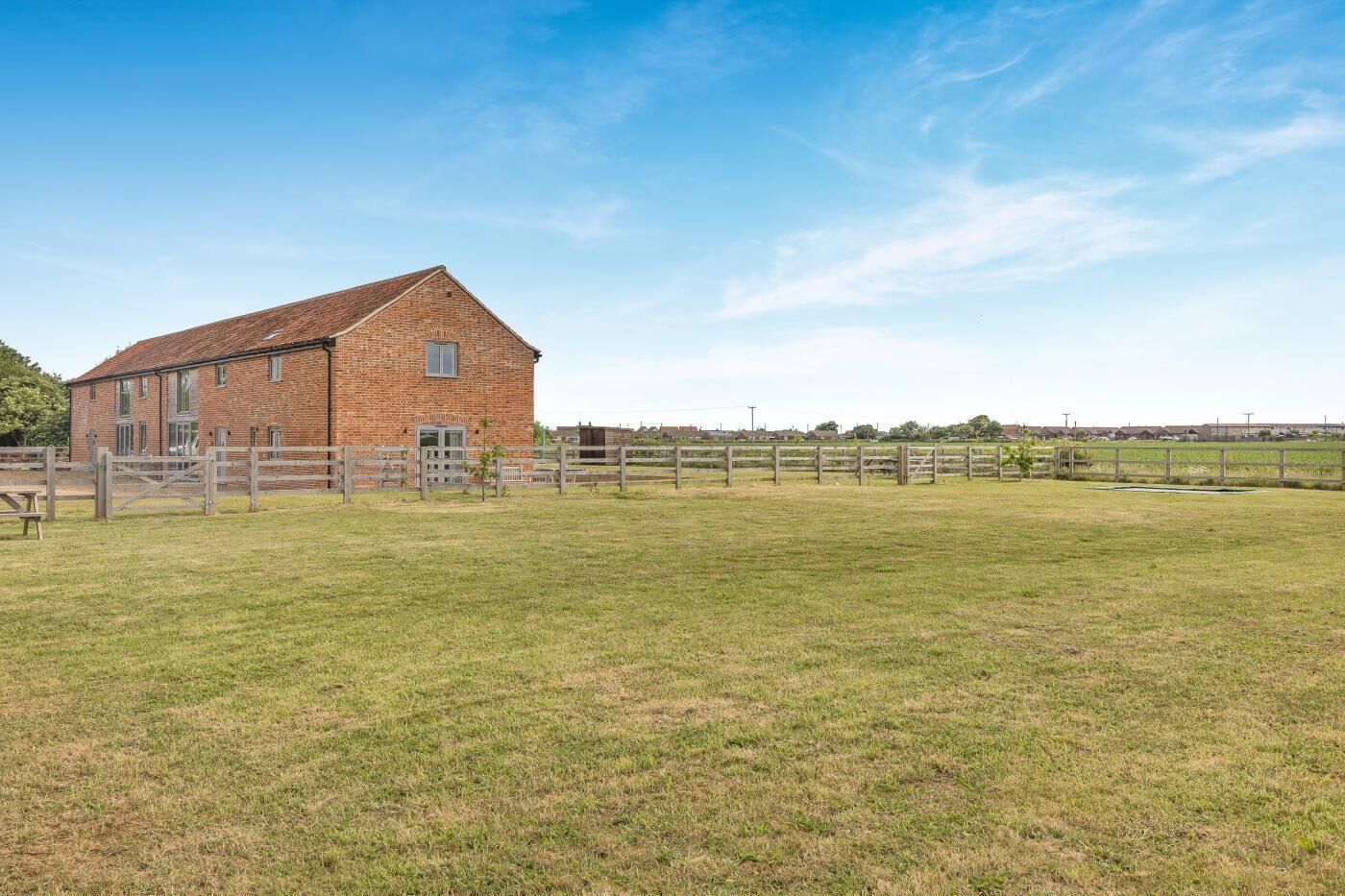 A brick building with a fenced yard.