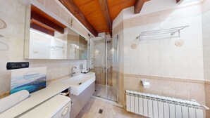 A bathroom with a shower, a sink, a mirror, and a towel rack. - Lido Apartment by Booking Lake Garda (Manerba del Garda)