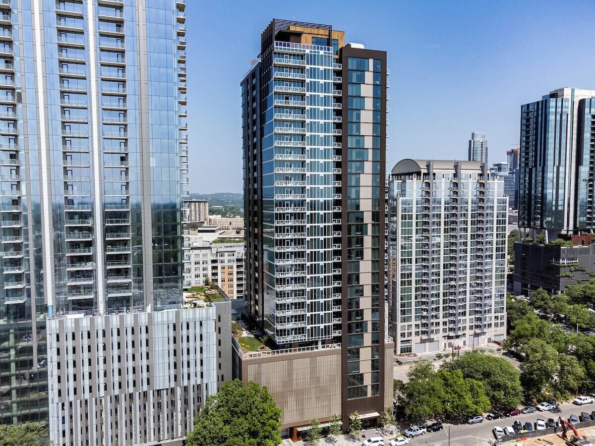 A high-rise building with multiple floors, large windows, and a modern architectural design.