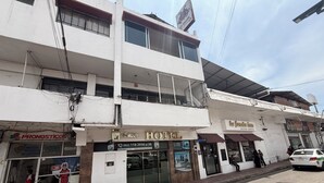 A two-story building with a hotel, a restaurant, and a pharmacy. - EL BARON HOTEL (Tapachula)