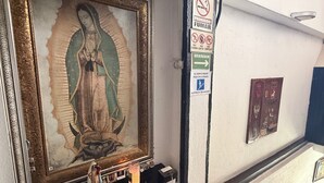 A staircase leading to an upper floor with a religious painting on the wall and a no-smoking sign. - EL BARON HOTEL (Tapachula)
