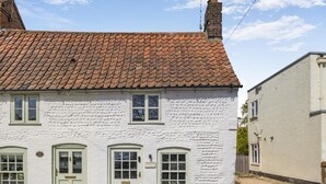 A white building with a tiled roof, two doors, and windows. - 1 Bed in Holt (oc-p34797) (Holt)