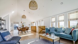 A spacious living area with a sofa, coffee table, and dining table. - 3 Bed in St. Eval (oc-s32502) (Saint Eval)