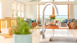 A dining area with a table set for four, a sink, and a view of the outdoors. - 3 Bed in St. Eval (oc-s32502) (Saint Eval)
