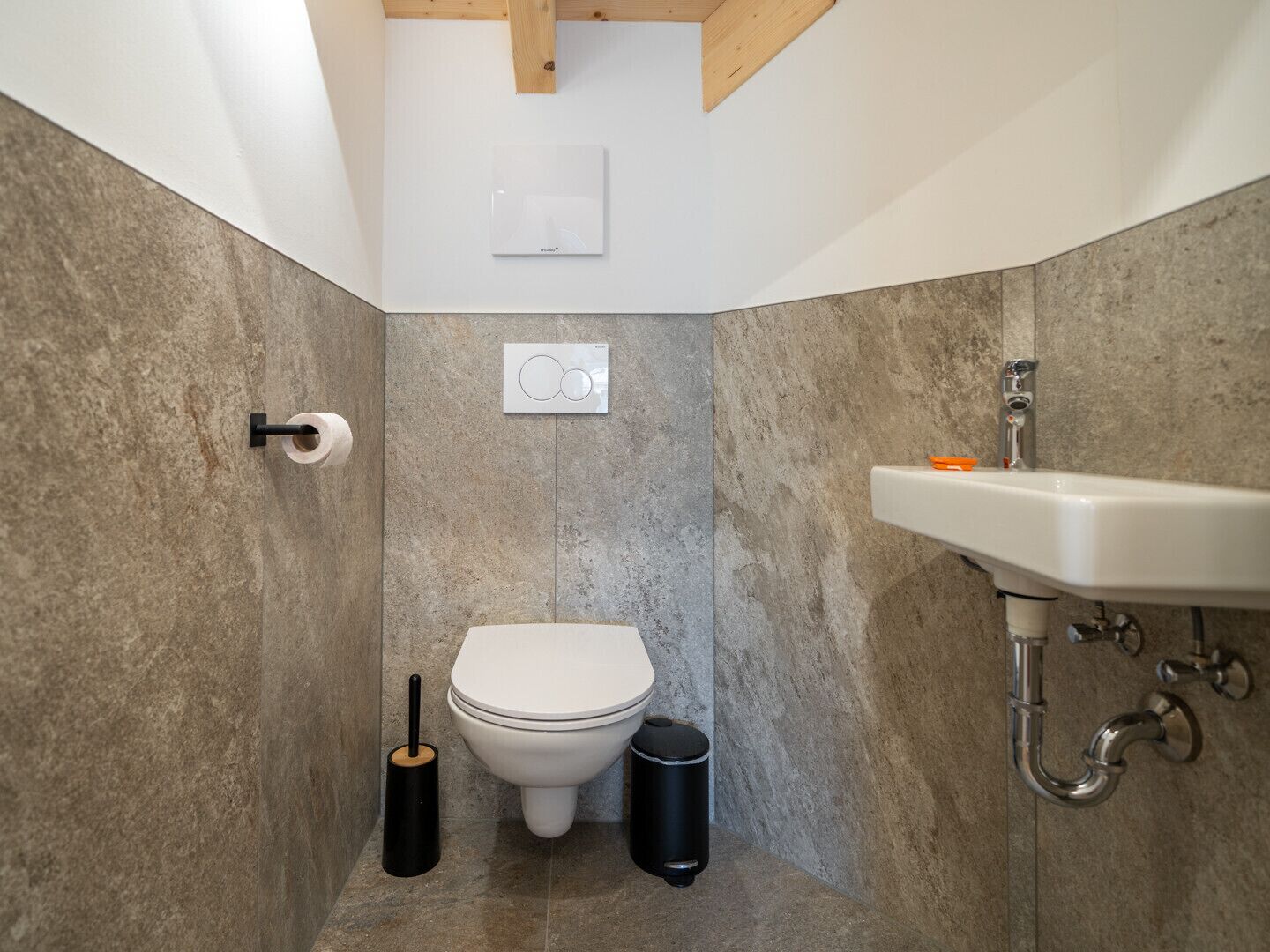 A bathroom with a toilet, bidet, and sink.