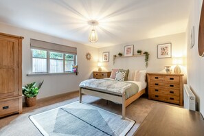 A bedroom with a bed, bedside tables, a dresser, a window, and a ceiling light fixture. - 3 Bed in Hopton Wafers (oc-r34993) (Crumpsbrook)