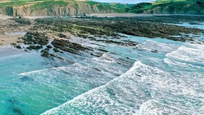 A coastal landscape with rocky shores and waves.
