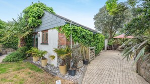 A house with a brick exterior, a tiled roof, and a paved driveway. - 2 Bed in Bude (oc-c34841) (Bude)