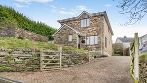 A stone house with a brick pathway leading to a gated entrance. - 3 Bed in Polruan (oc-l35010) (Fowey)