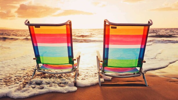 Two beach chairs facing the ocean with a sunset in the background. - Dew Drop Inn Resort Villa with Massive Pool Oasis (North Myrtle Beach)
