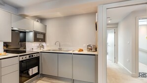 A modern kitchen with a built-in oven, microwave, and stainless steel appliances. - 1 Bed in Keswick (oc-t35027) (Keswick)