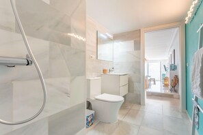 A modern bathroom with a shower, toilet, and sink. - Coastal Escape with Private Pool for 6 (San José)