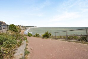 A coastal path with a railing, leading to a beach. - 3 Bed in Broadstairs (oc-n34799) (Broadstairs)