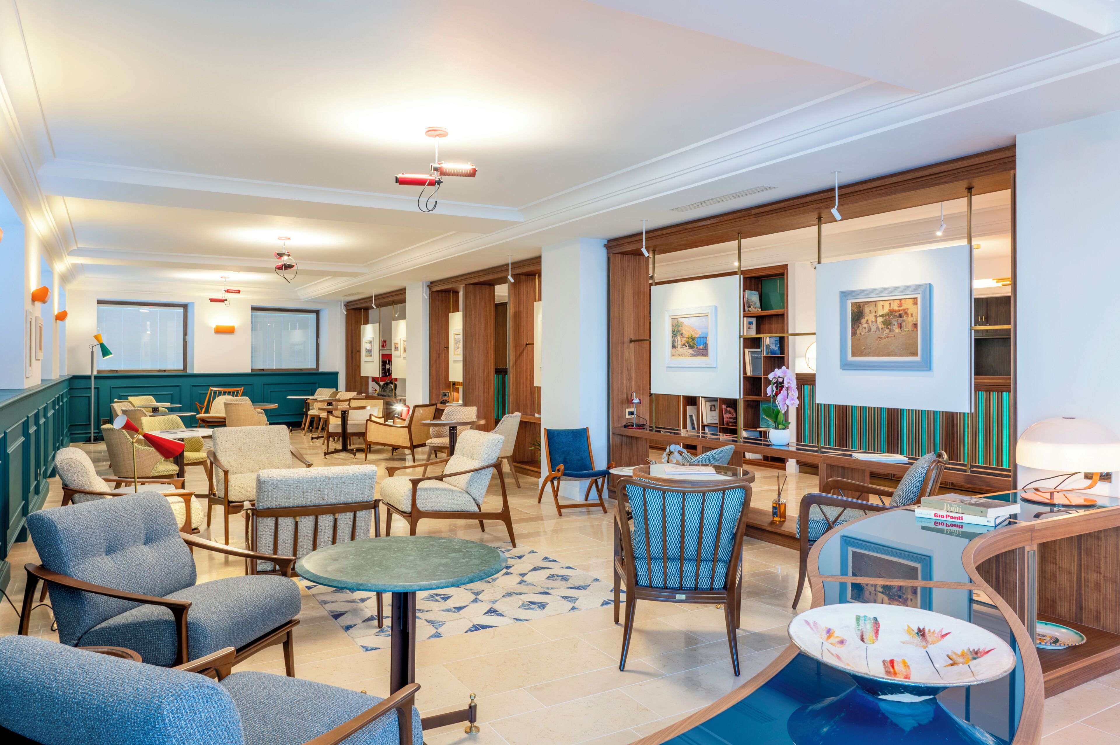 Un hall de hotel con una zona de estar, un bar y un comedor.