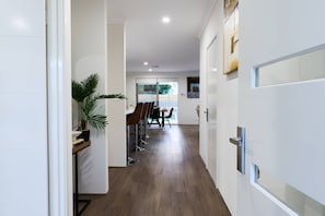A hallway with a dining area, wooden flooring, and a potted plant. - 47A Westlake Road Morley is a Perfect 4-bedroom house with AC in gorgeous Morley (Morley)