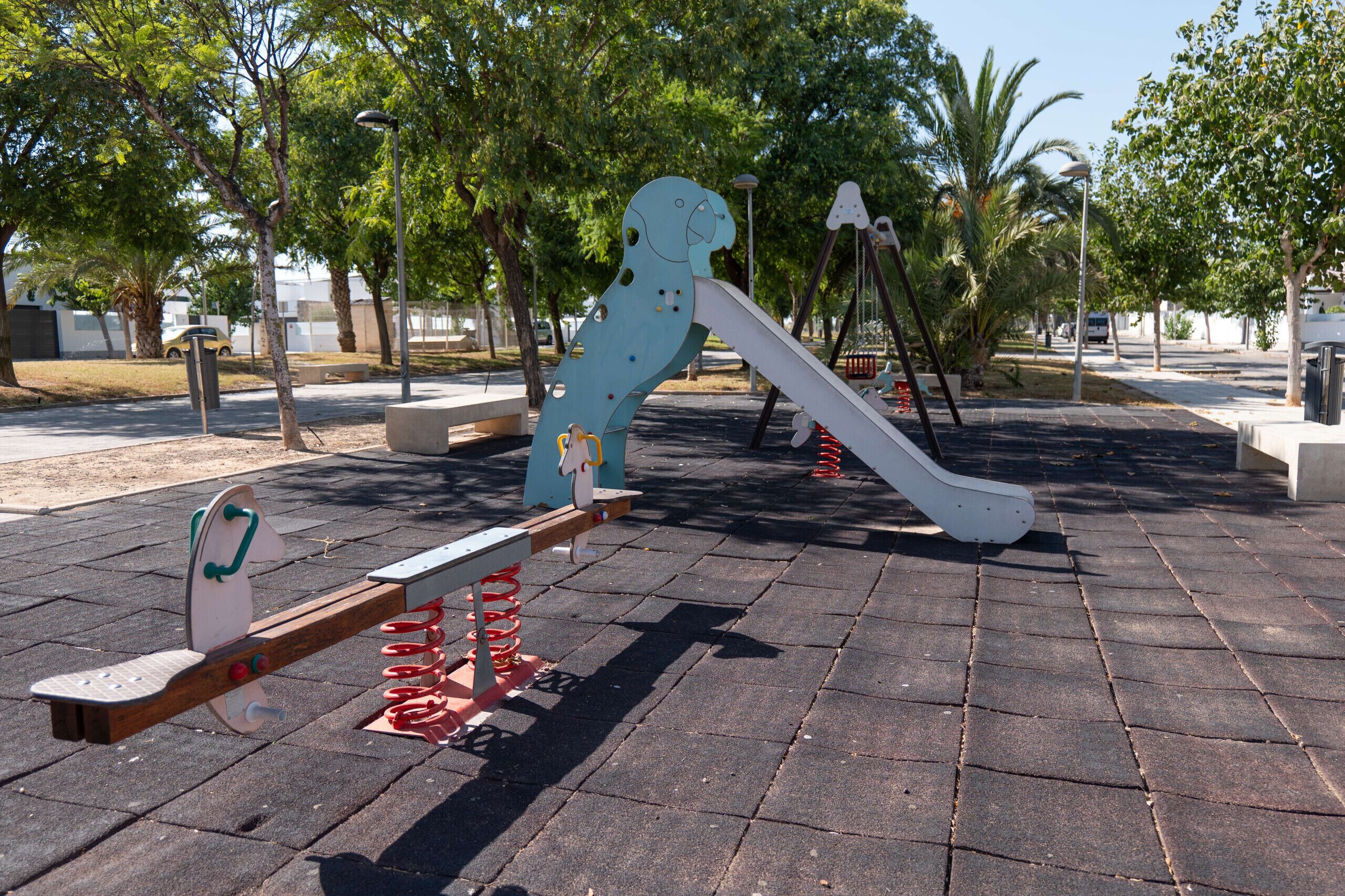 A playground with seesaws and a slide.