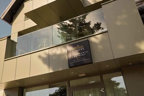 A modern building with a sign advertising apartments for rent. - Persante Sunrise Collection 1 | Riverside | AC (Kołobrzeg)