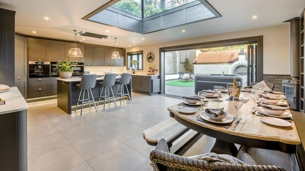 A modern kitchen with a skylight, bar area, and dining space. - 4 Bed in East Dean (oc-l34384) (East Dean)