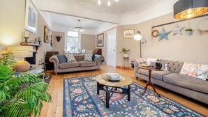 A living room with two sofas, a coffee table, and a patterned rug. - 3 Bed in Castle Douglas (oc-c35143) (Castle Douglas)