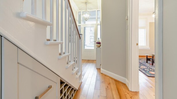 A staircase leading to a room with a large window, wooden flooring, and a chandelier. - 3 Bed in Castle Douglas (oc-c35143) (Castle Douglas)