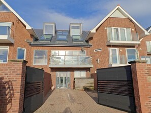 A two-story residential building with a central balcony, a garage, and a brick facade. - 5 Bed in Blyth (oc-t34727) (Blyth)