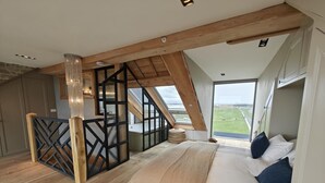 A bedroom with a bed, a view of the outdoors, and a staircase. - 5 Bed in Blyth (oc-t34727) (Blyth)