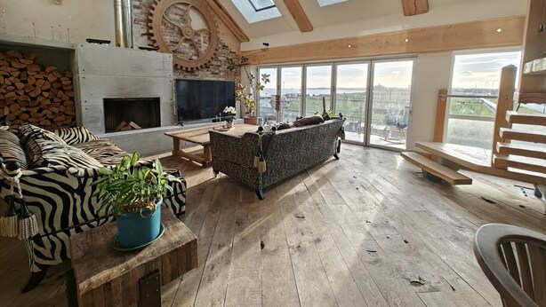 A spacious living area with a fireplace, a large TV, and a view of the city. - 5 Bed in Blyth (oc-t34727) (Blyth)