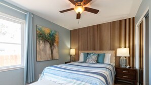 A bedroom with a bed, two bedside tables, a ceiling fan, a painting, and a window. - Prime Location Near Gaylord Resort & Bayfront (Chula Vista)