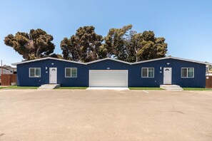 A single-story building with a garage door, a front entrance, and a small porch. - Prime Location Near Gaylord Resort & Bayfront (Chula Vista)