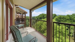 Ein Balkon mit Blick auf ein bewaldetes Gebiet.