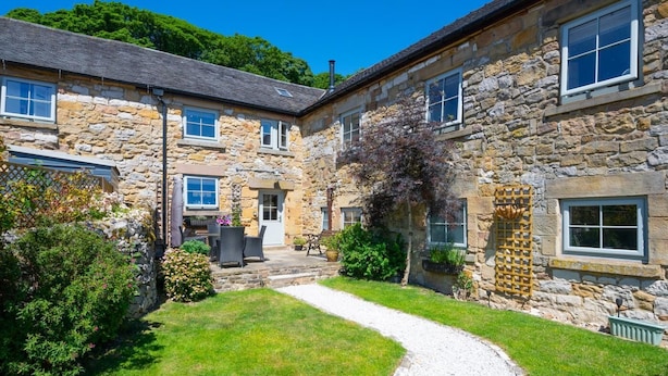 A stone building with a gravel path, a patio with outdoor furniture, and a garden. - 3 Bed in Wirksworth (oc-dchenm) (Hopton)