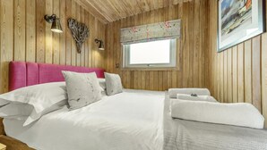 A wooden-paneled room with a bed, pillows, a window, and a painting. - 1 Bed in Gatehouse Of Fleet (oc-d34894) (Gatehouse of Fleet)