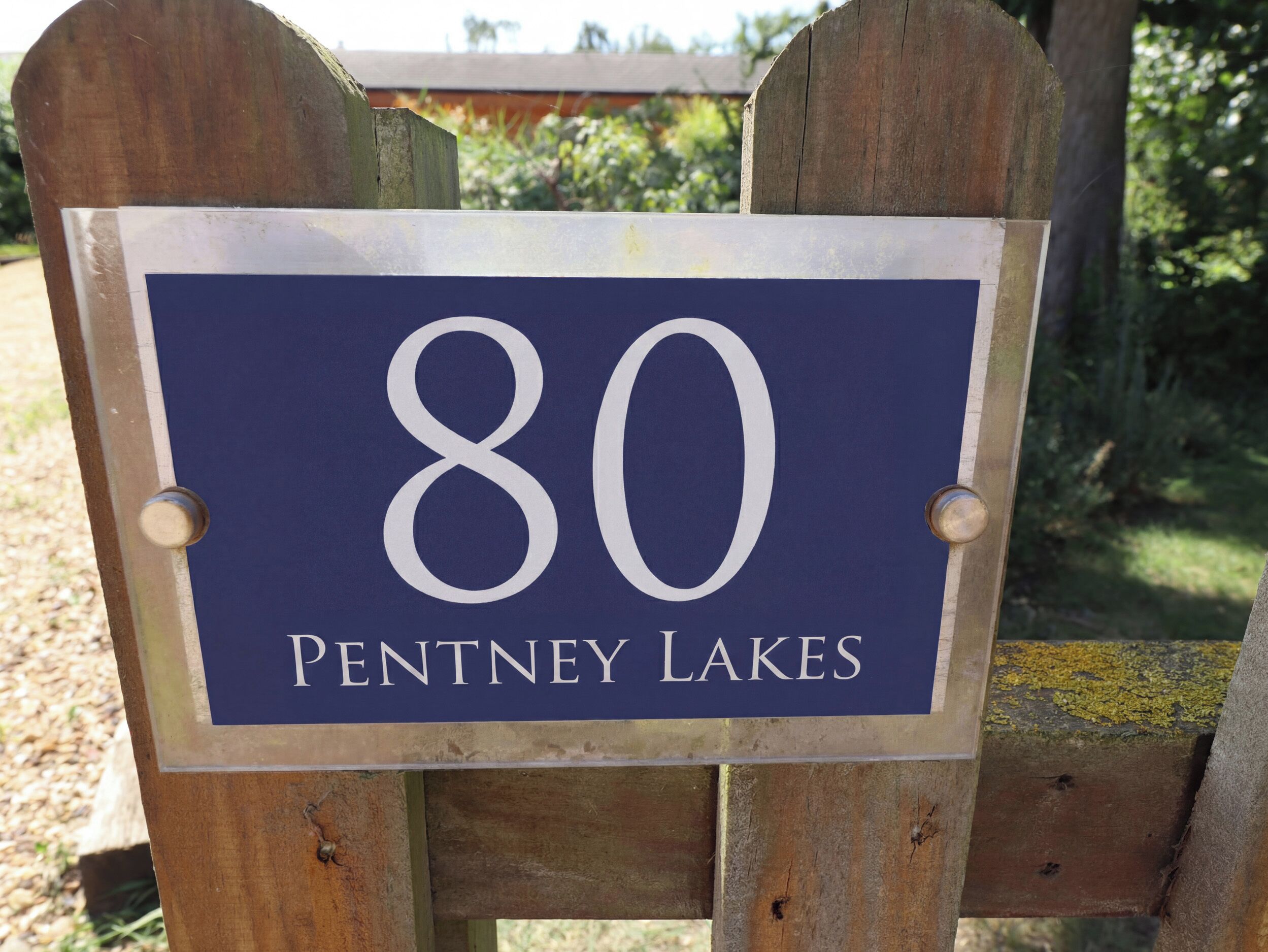 A wooden sign with the number 80 and the text 'PENTNEY LAKES' on it.