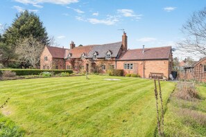A large brick house with a well-maintained lawn and garden. - 4 Bed in Shrawley (oc-s34861) (Shrawley)