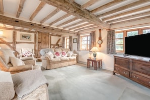 A rustic room with exposed wooden beams, a sofa set, a television, and a small table with a lamp. - 4 Bed in Shrawley (oc-s34861) (Shrawley)